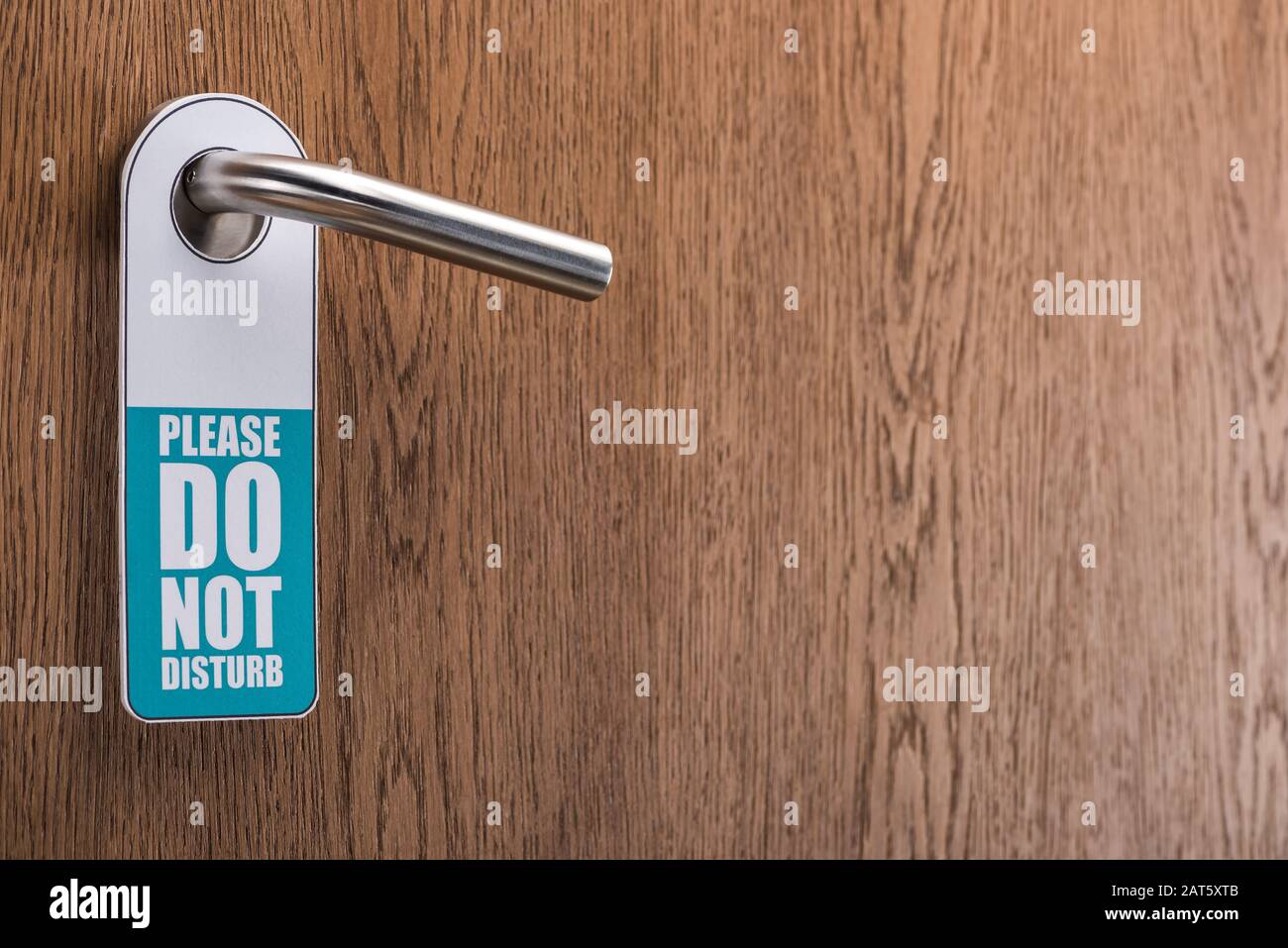 wooden hotel room door with please do no disturb sign on handle Stock ...