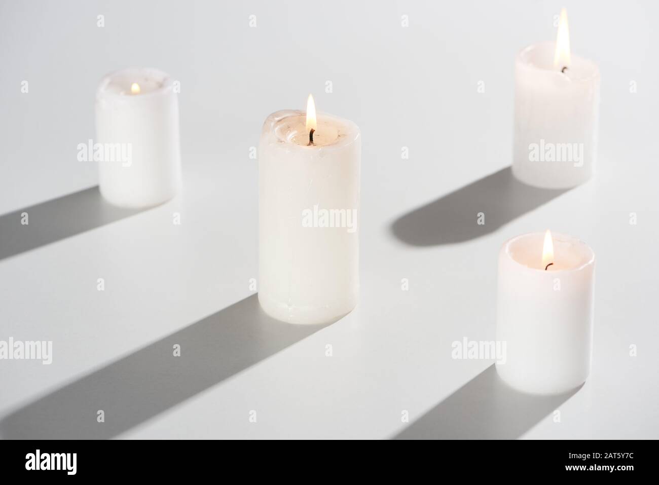 burning candles glowing on white background with shadow Stock Photo Alamy