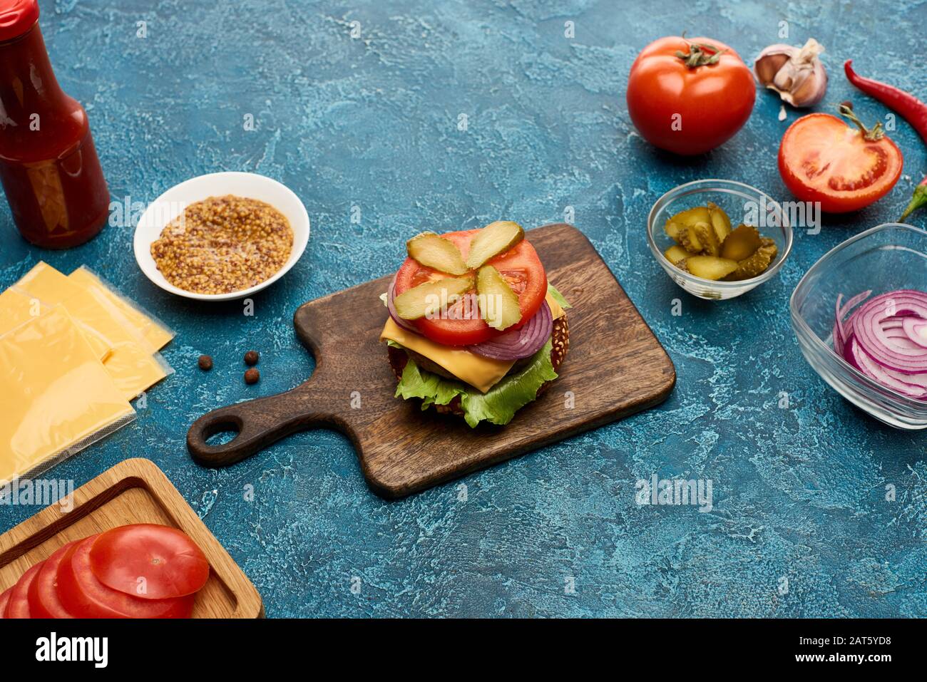 fresh burger ingredients on blue textured surface Stock Photo - Alamy