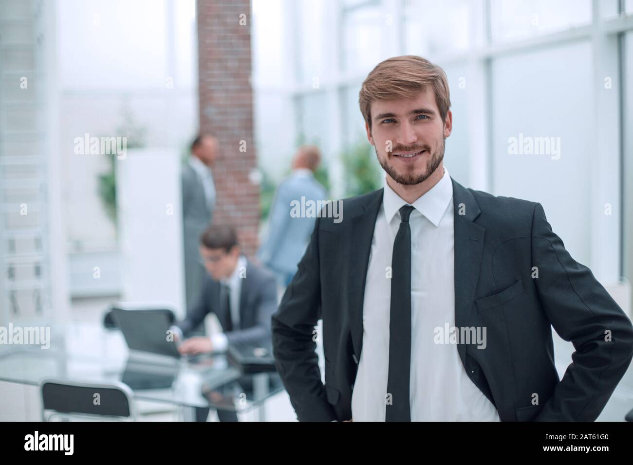 close up. smiling businessman standing in his office Stock Photo - Alamy