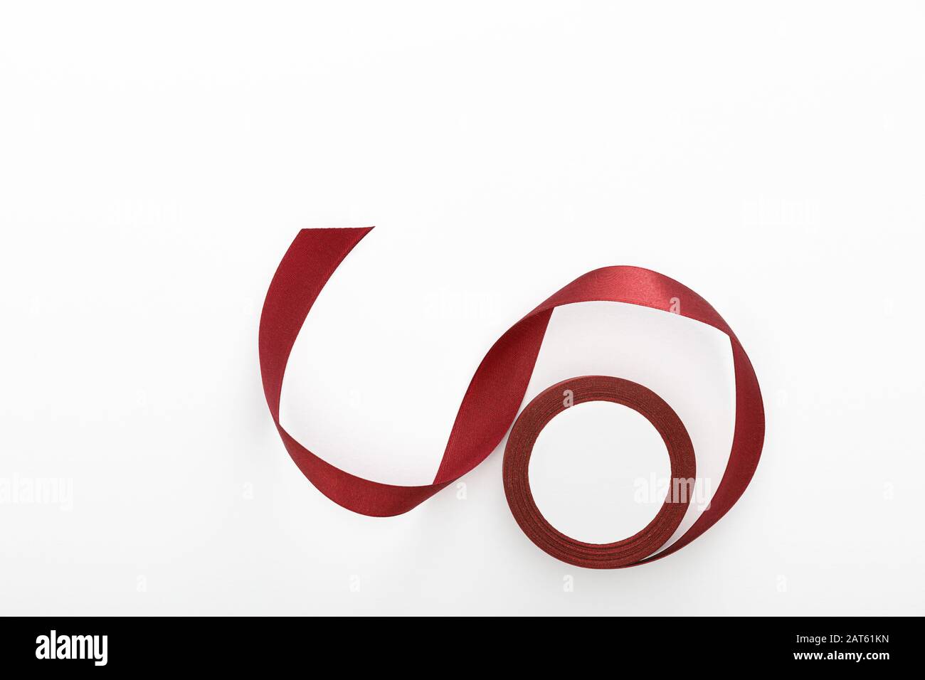 top view of satin burgundy decorative curved ribbon isolated on white Stock Photo