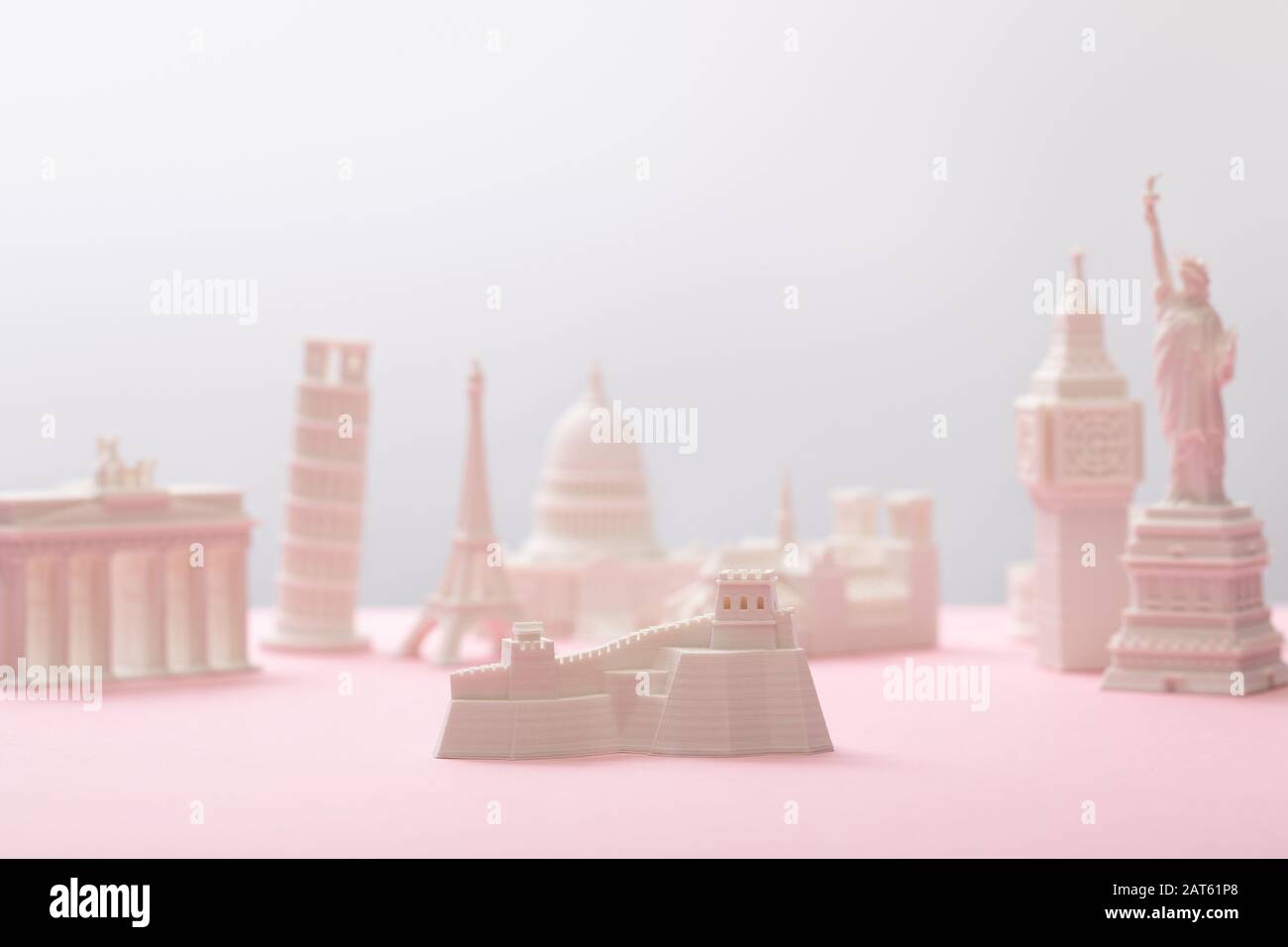 selective focus of great wall figurine near statuettes on grey and pink Stock Photo