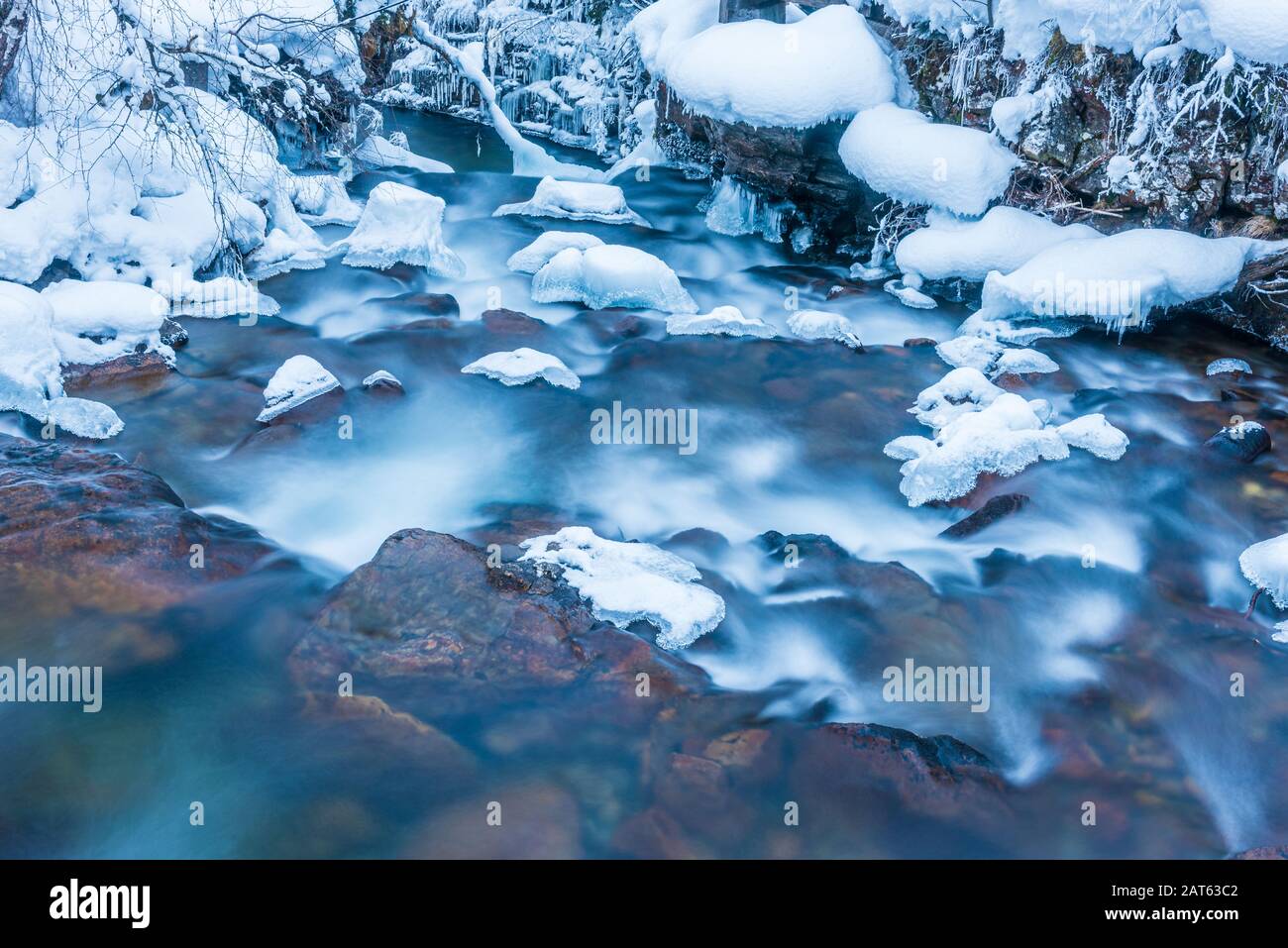 Winter landscape of a small mountain river with colourful stones ...