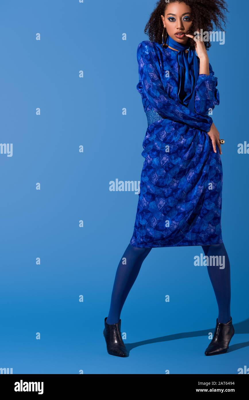 attractive african american woman in dress on blue background Stock ...