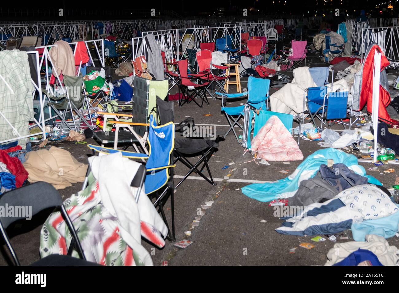 Chairs, blankets, and garbage left behind in the waiting and overflow area of the 'Keep America Great' rally; as seen after the event's completion. Stock Photo