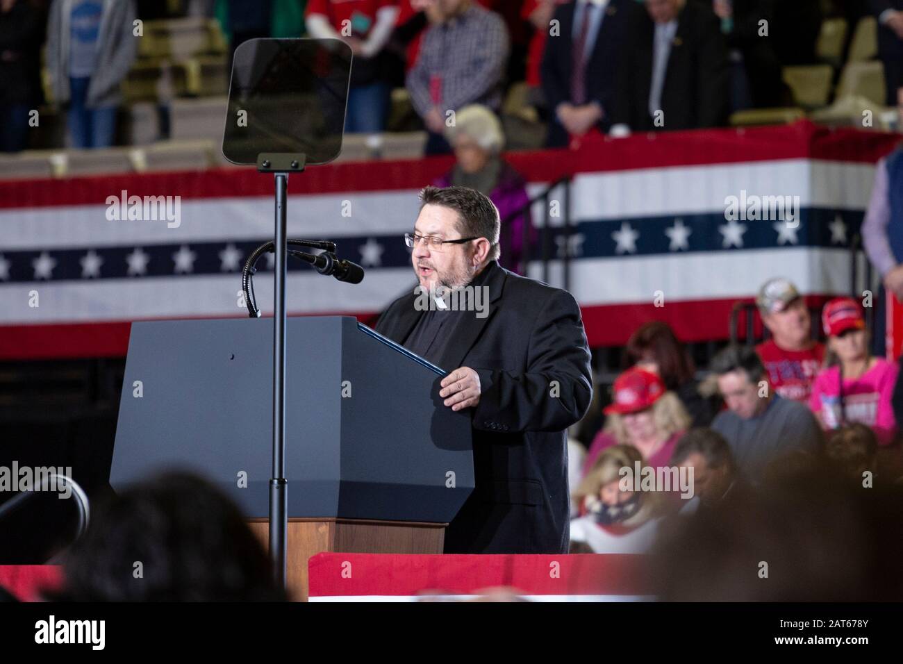 Priest leads the audience in prayer at the 'Keep America Great' rally held at the Wildwoods Convention Center. Stock Photo