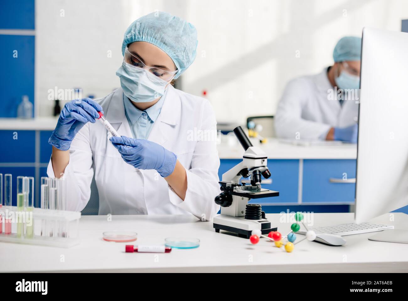 Genetics Lab Coat genetic consultant in white coat doing dna test in lab Stock Photo - Alamy