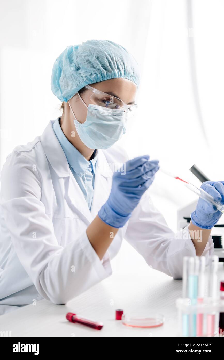Genetics Lab Coat genetic consultant in white coat doing dna test in lab Stock Photo - Alamy