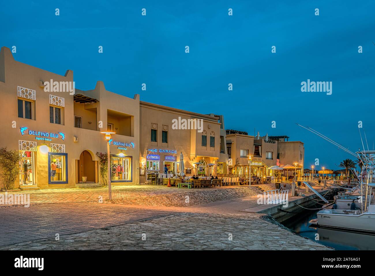 illuminated shopfronts lying on the promade along the Abu Tig marina in el Gouna, Egypt, January 14, 2020 Stock Photo