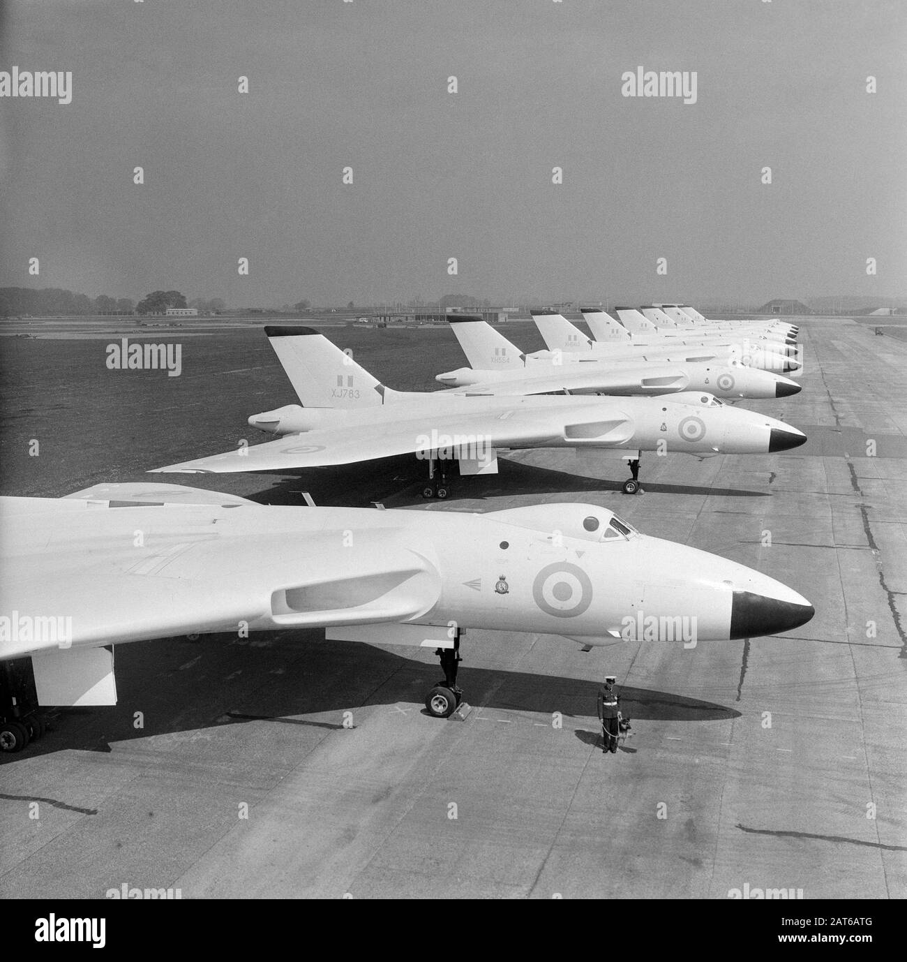 A line up of British Royal Air Force Avro Vulcan B.2 Bombers, taken at RAF Scampton on 11th May 1961. Aircraft include XJ783, XH554, XH563, XJ821, XH558. All painted in the all white anti-flash colour scheme. Stock Photo