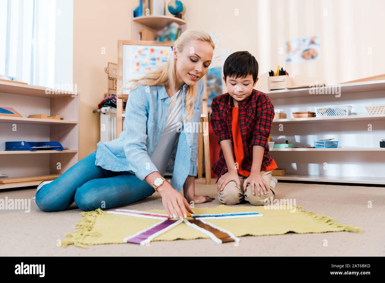 Selective focus of asian kid playing educational game with teacher on ...