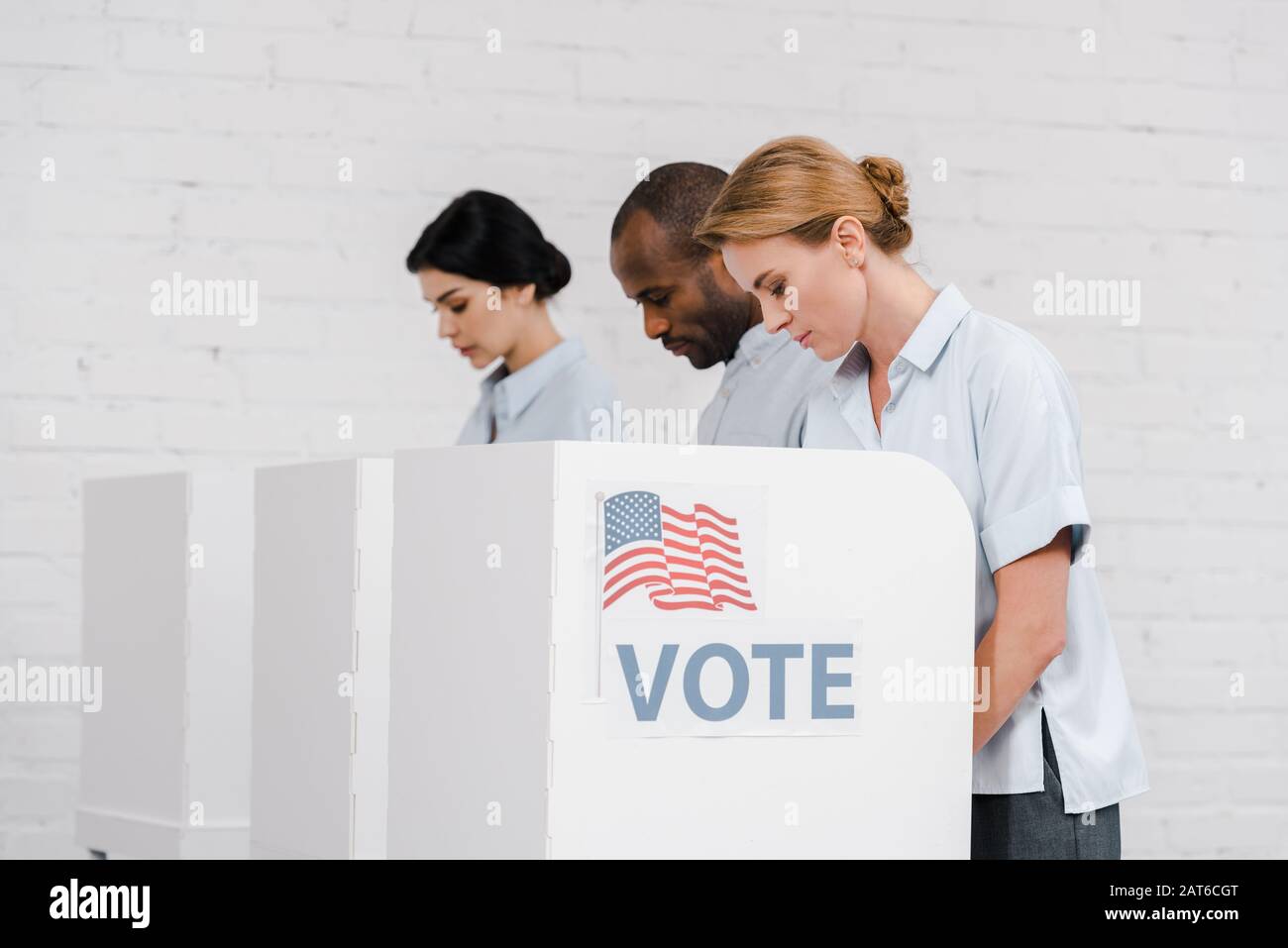 side view of women and african american man voting near vote lettering ...