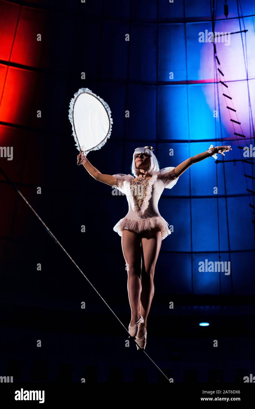 aerial acrobat holding racket while balancing on rope Stock Photo - Alamy