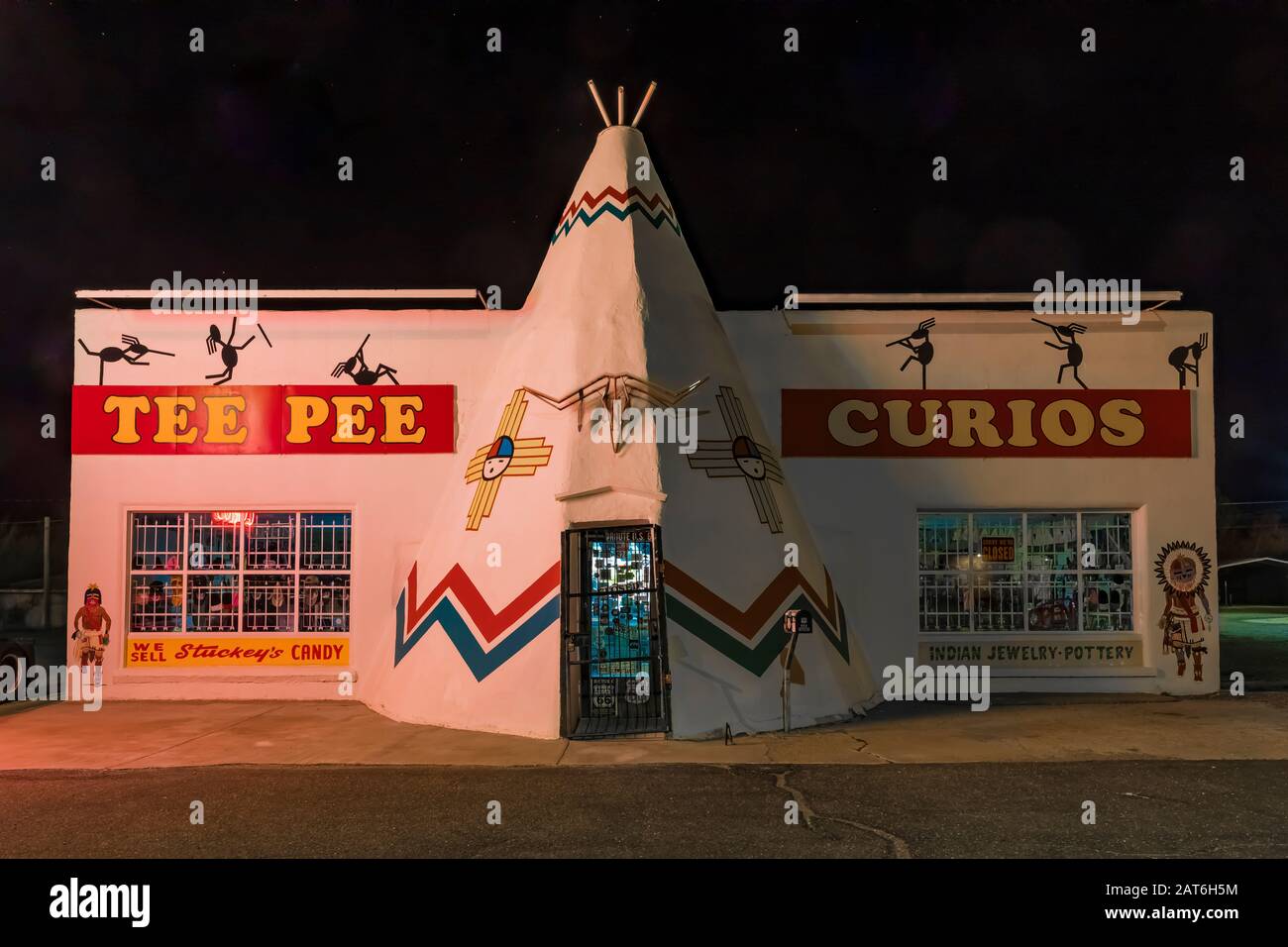 Tepee Curios shop, with murals painted by artist Doug Quarles, at night along Historic Route 66