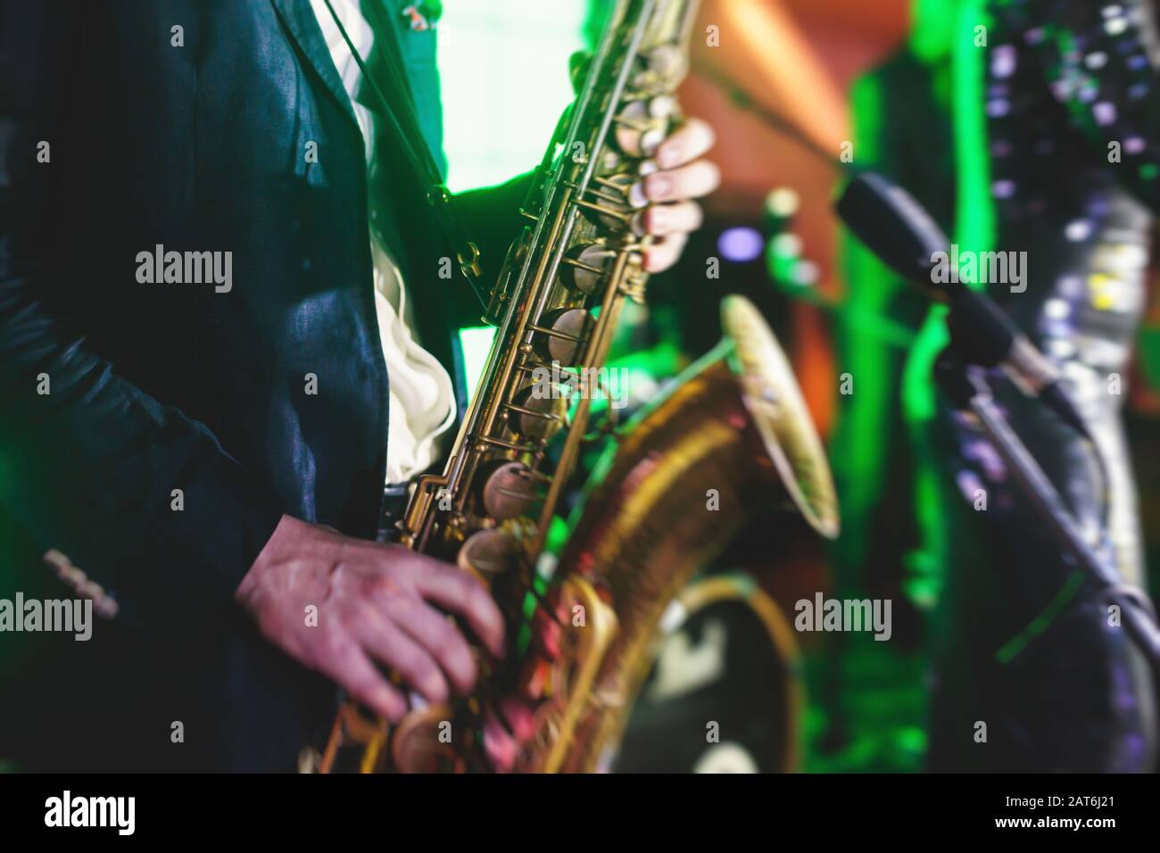 Concert view of a saxophone player with vocalist and musical jazz band
