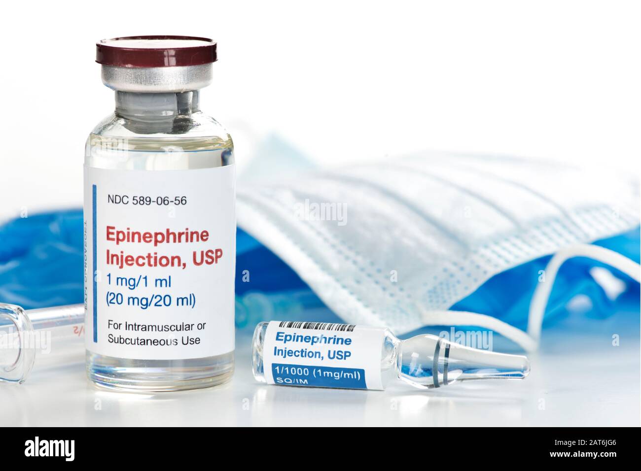 Epinephrine injection solution in 20 ml vial and clear1 ml ampule with mask, gloves and syringe. Stock Photo
