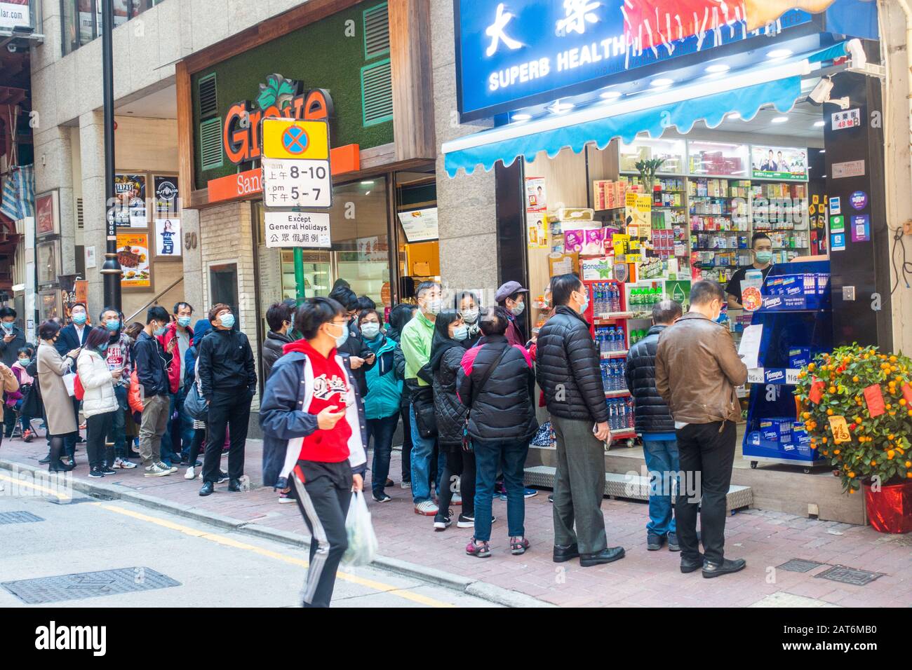 Hong Kong - January 30th, 2020: People line at pharmacy to buy surgical masks in the fear of Wuhan Coronavirus Stock Photo