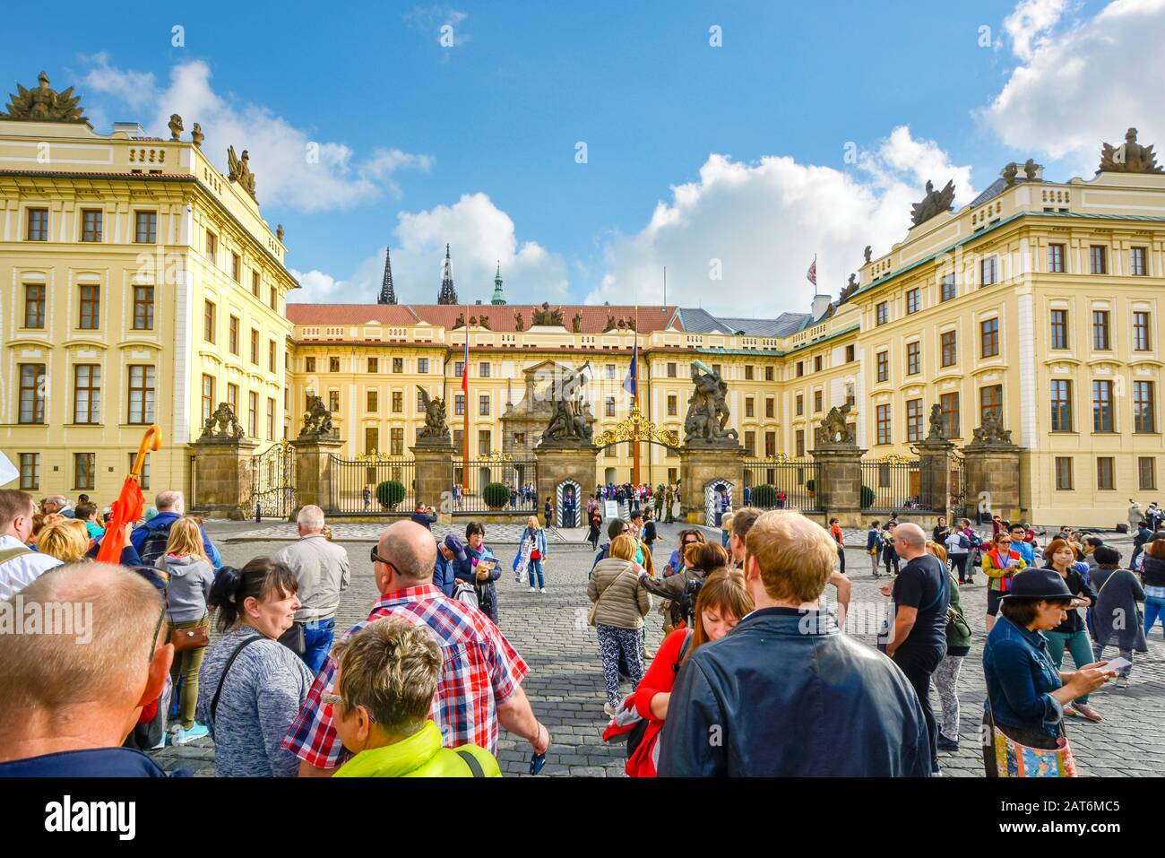 Tourists wait outside the courtyard of the Royal Palace for the changing of the guard at Prague Castlle Complex in Czechia. Stock Photo
