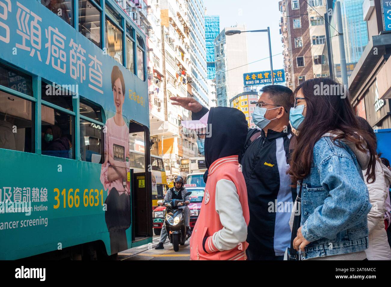 Hong Kong - January 30th, 2020: People  wearing surgical masks in the fear of Wuhan Coronavirus. Stock Photo