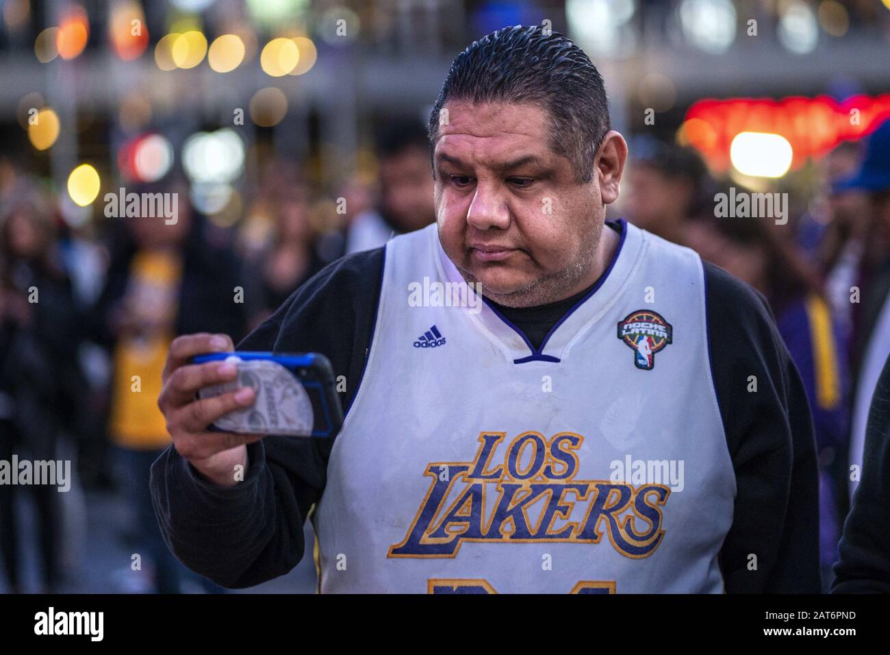Los Angeles, USA. 15th Mar, 2019. A fan takes pictures of a makeshift memorial in honour of the former NBA star Kobe Bryant outside the Staples Center in Los Angeles.Kobe and his daughter Gianna were among the nine people who died in a helicopter crash. Credit: Ronen Tivony/SOPA Images/ZUMA Wire/Alamy Live News Stock Photo