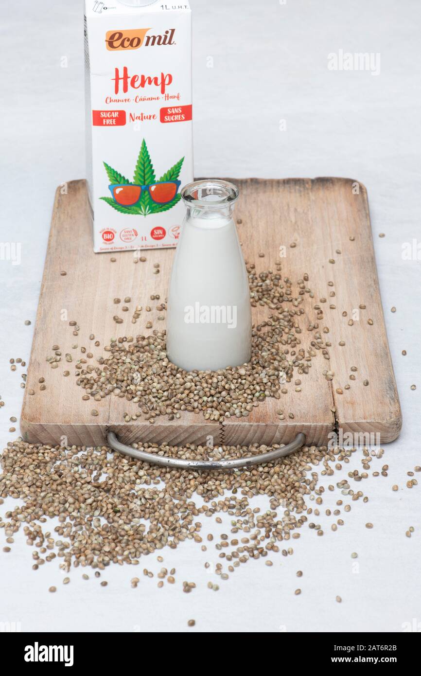 Vegan plant based milk alternatives. Vegan milk alternatives. Hemp seed milk with hemp seeds on a wooden board Stock Photo