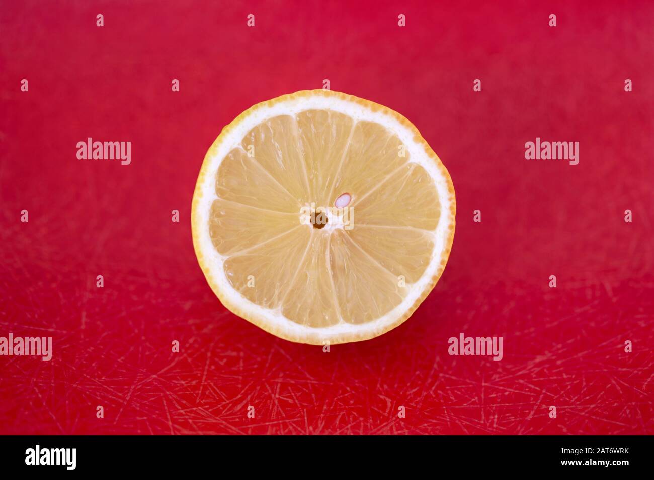 cut lemon close-up on red background Stock Photo