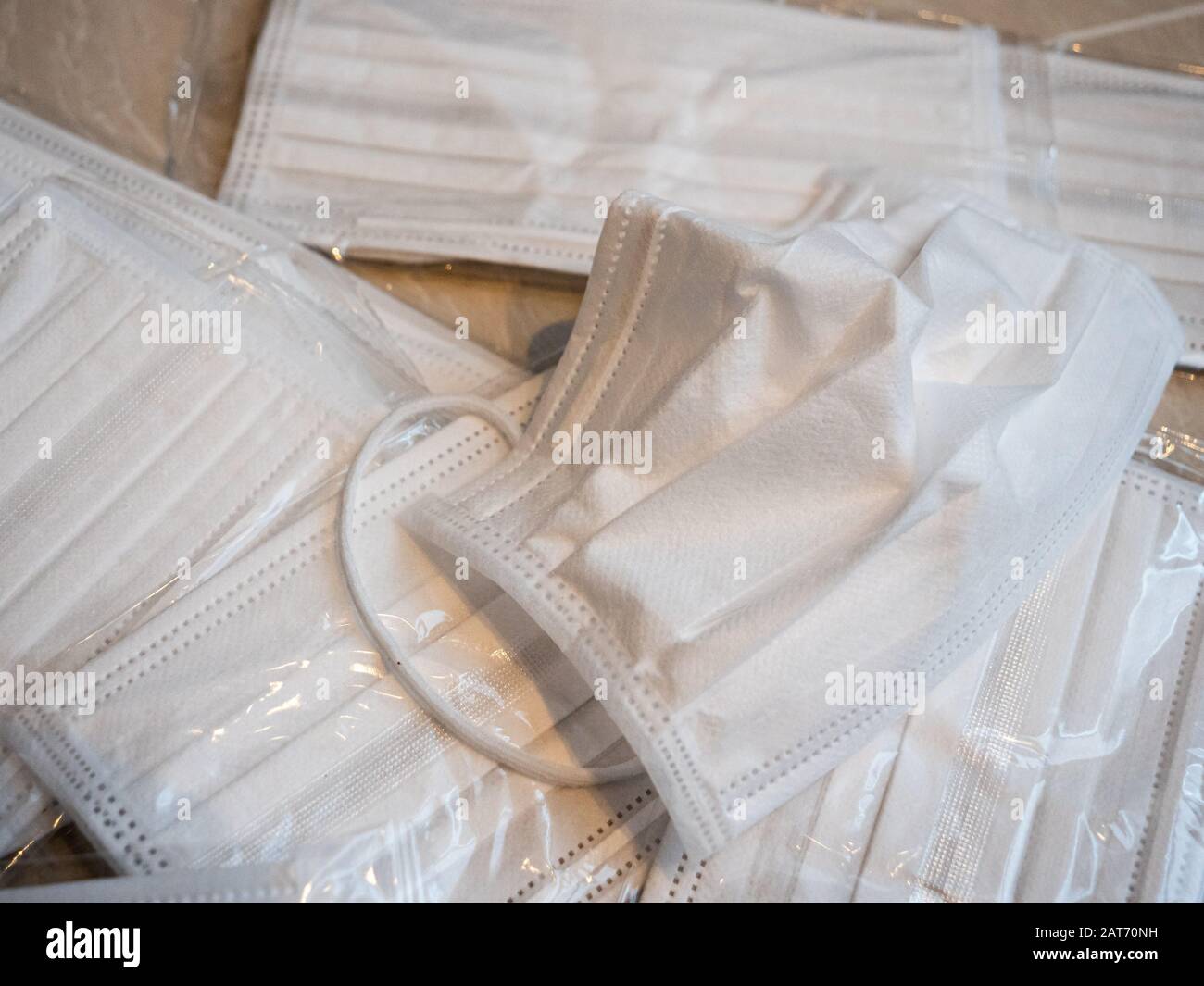 A pile of white surgical masks used to prevent the spread of viruses