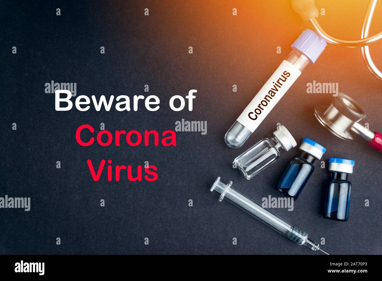 Stethoscope, Vial, Syringe and Specimen bottle with words BEWARE OF CORONAVIRUS on black background. Selective focus and crop fragment Stock Photo