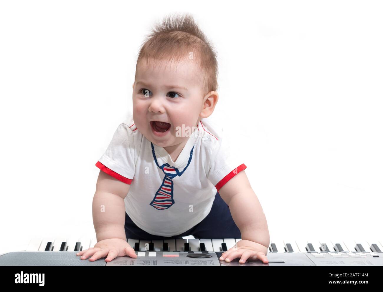 Little baby enjoying playing on piano (synthesizer), isolated on white