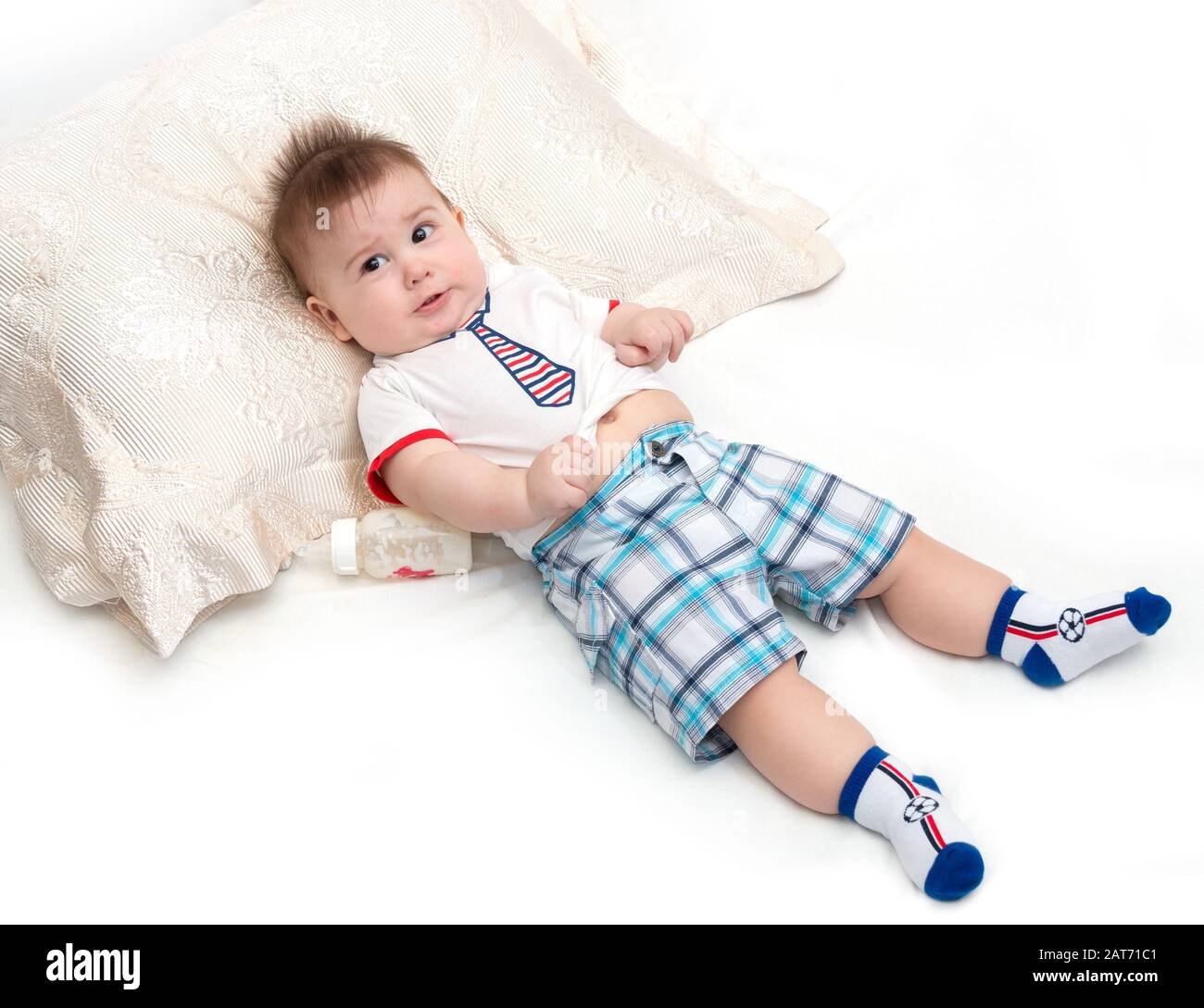 Little beautiful baby lying and pulling a face Stock Photo Alamy