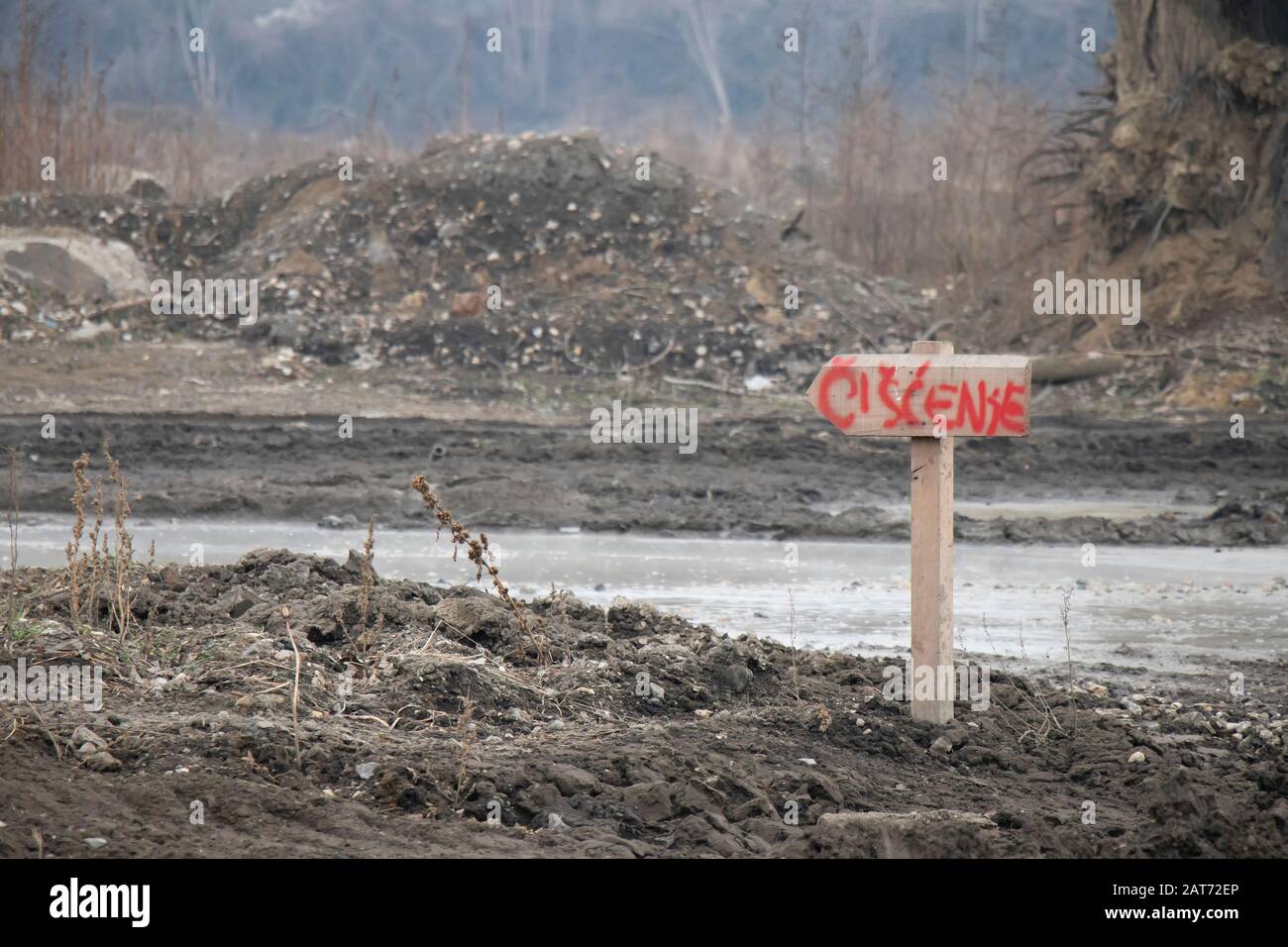 Belgrade, Serbia - January 26, 2020: Detail of a mud road on Waterfront construction site disposal area with wooden direction sign for cleaning Stock Photo