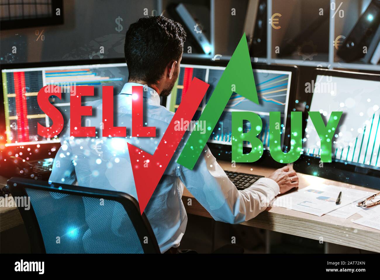back view of trader working near computer with graphs, sell and buy ...