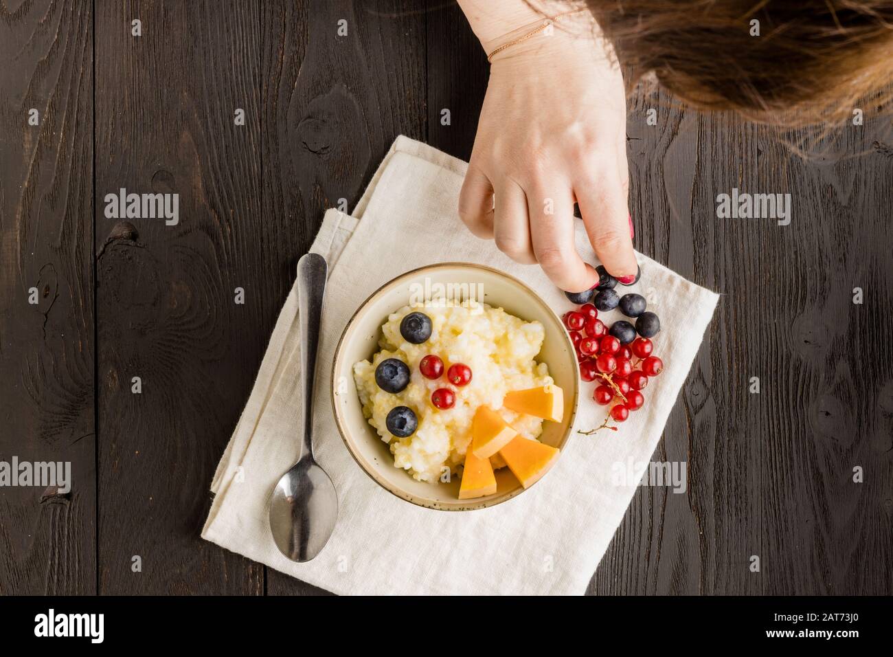 Rice milk porridge with nuts, berry and fruits Stock Photo