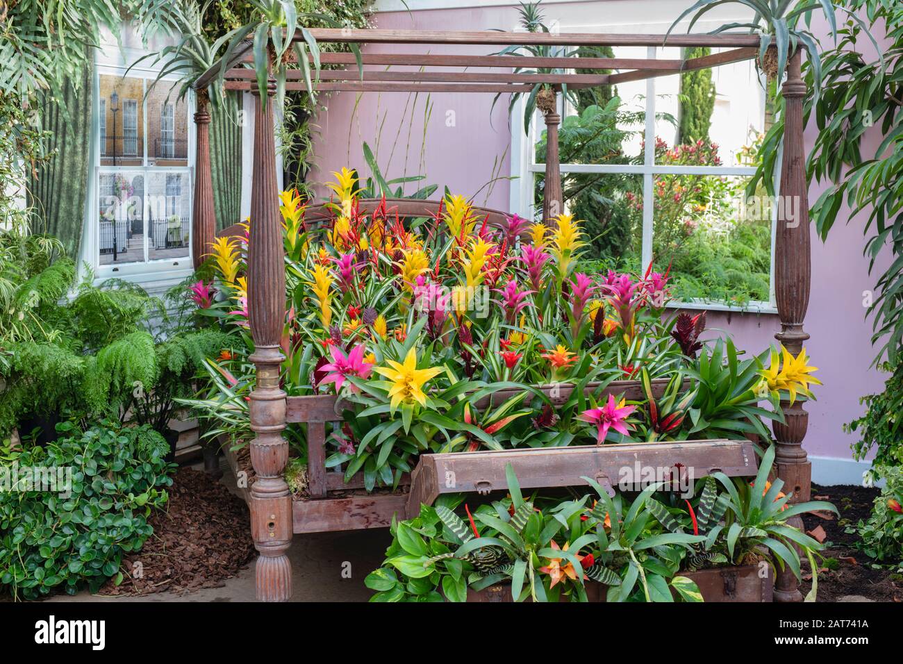 The Giant Houseplant Takeover display in the glasshouse at RHS Wisley gardens, Surrey, UK. Victorian house reclaimed by houseplants. January 2020 Stock Photo