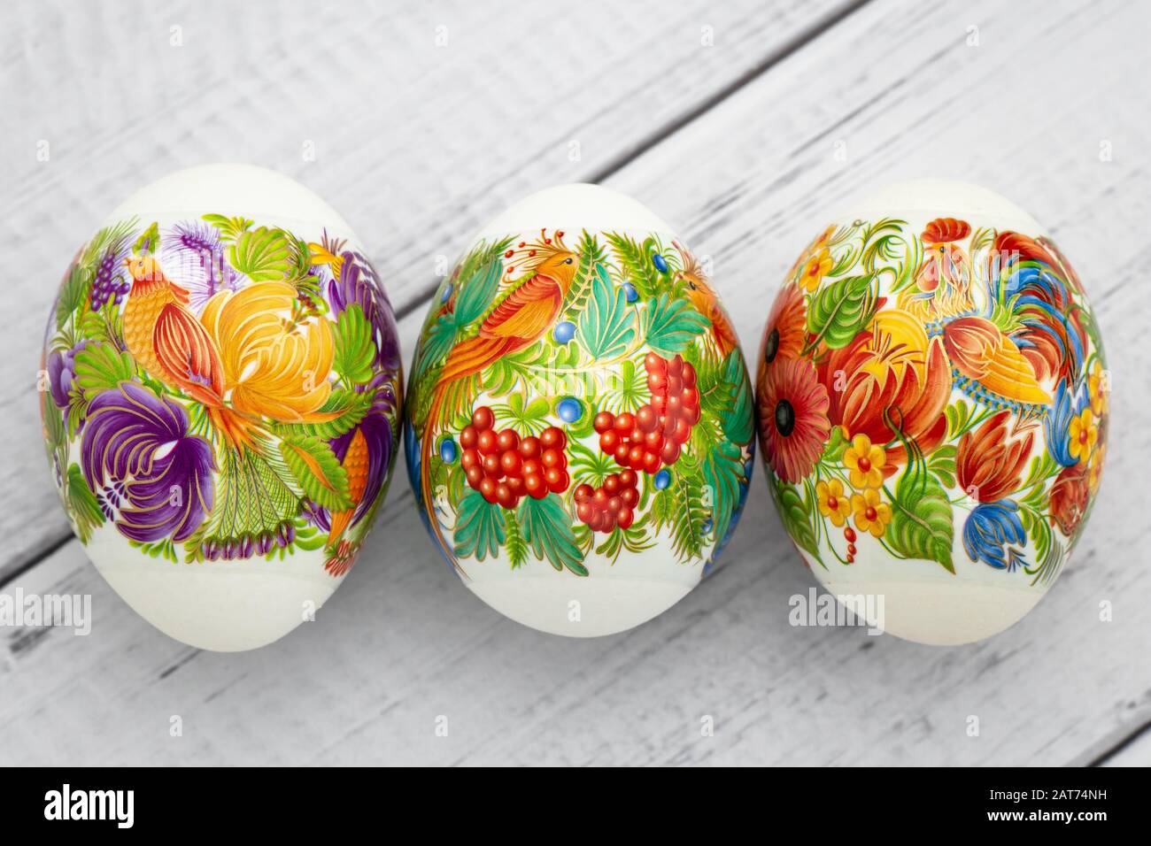 Festive easter gift card. Colorful eggs on wooden white background. Paschal decoration Stock Photo