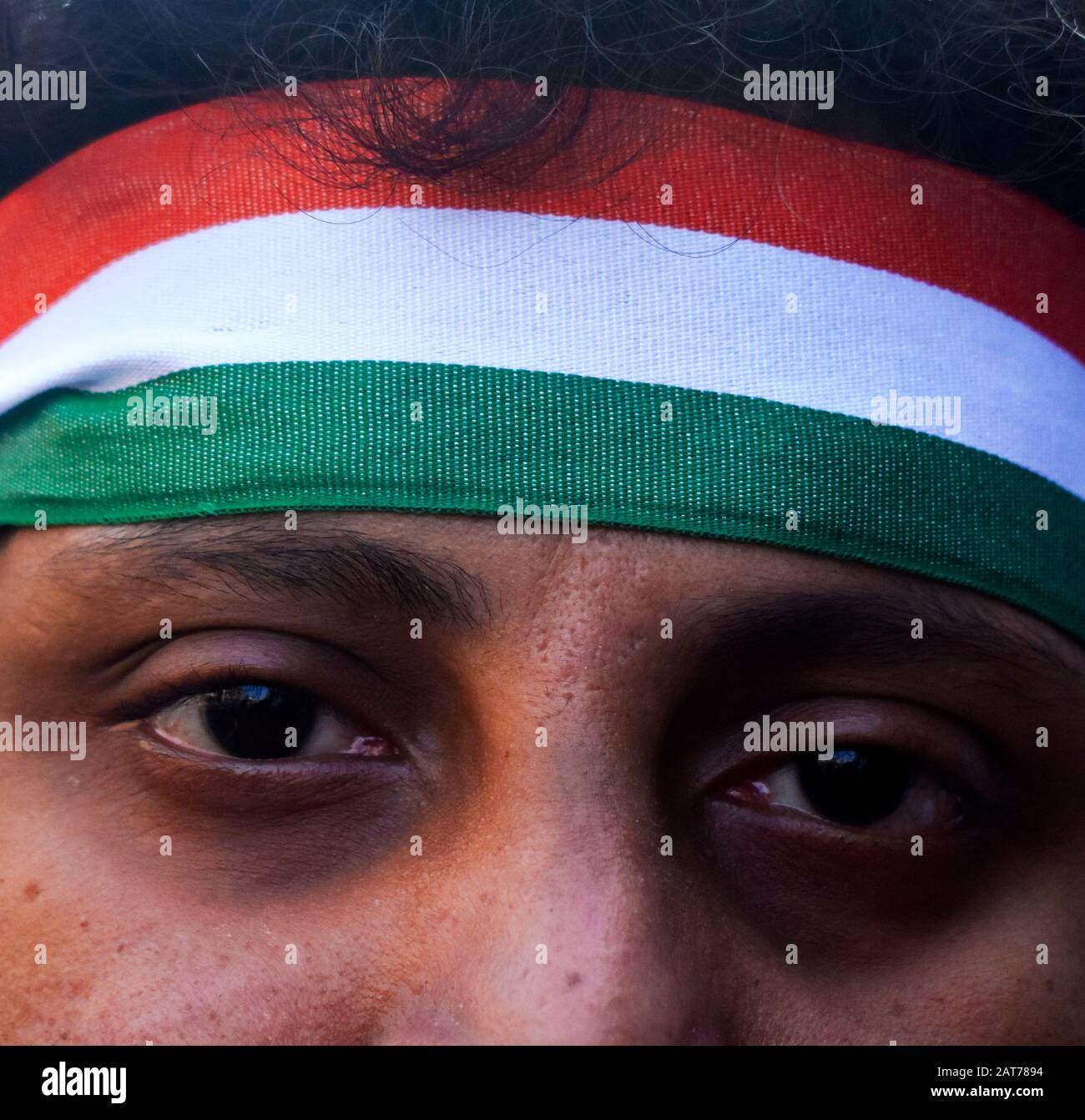 A protester is wearing tri colour ribbon on his head during a protest rally in Kolkata, India. Stock Photo