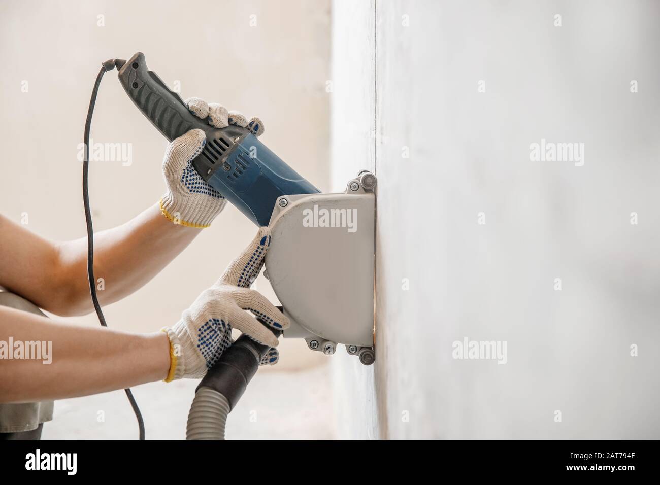 Builder man cutting electrical chase in concrete wall with circulation saw  drill diamond crown Stock Photo - Alamy