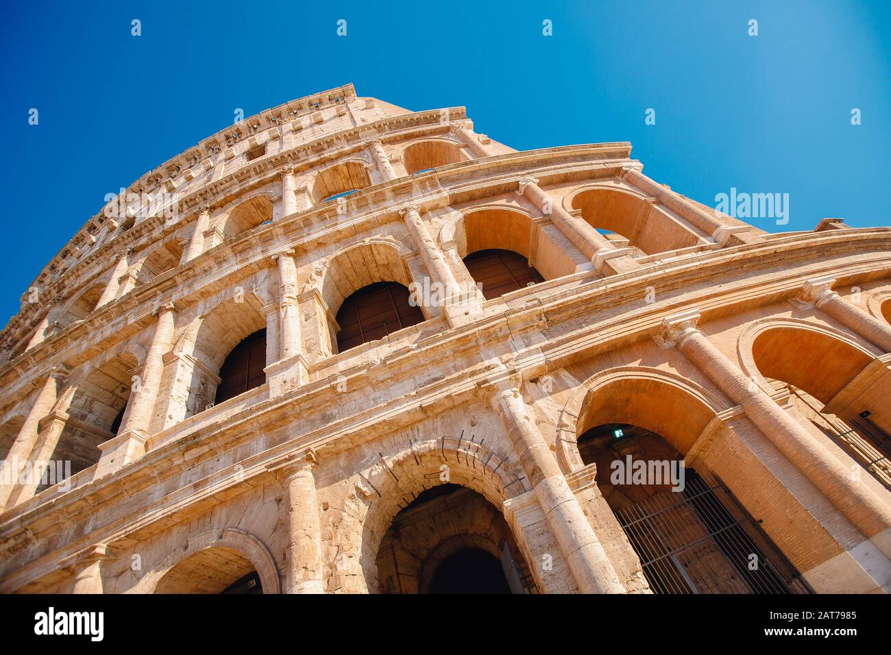 Colosseum or Coliseum ancient ruins background blue sky Rome, Italy