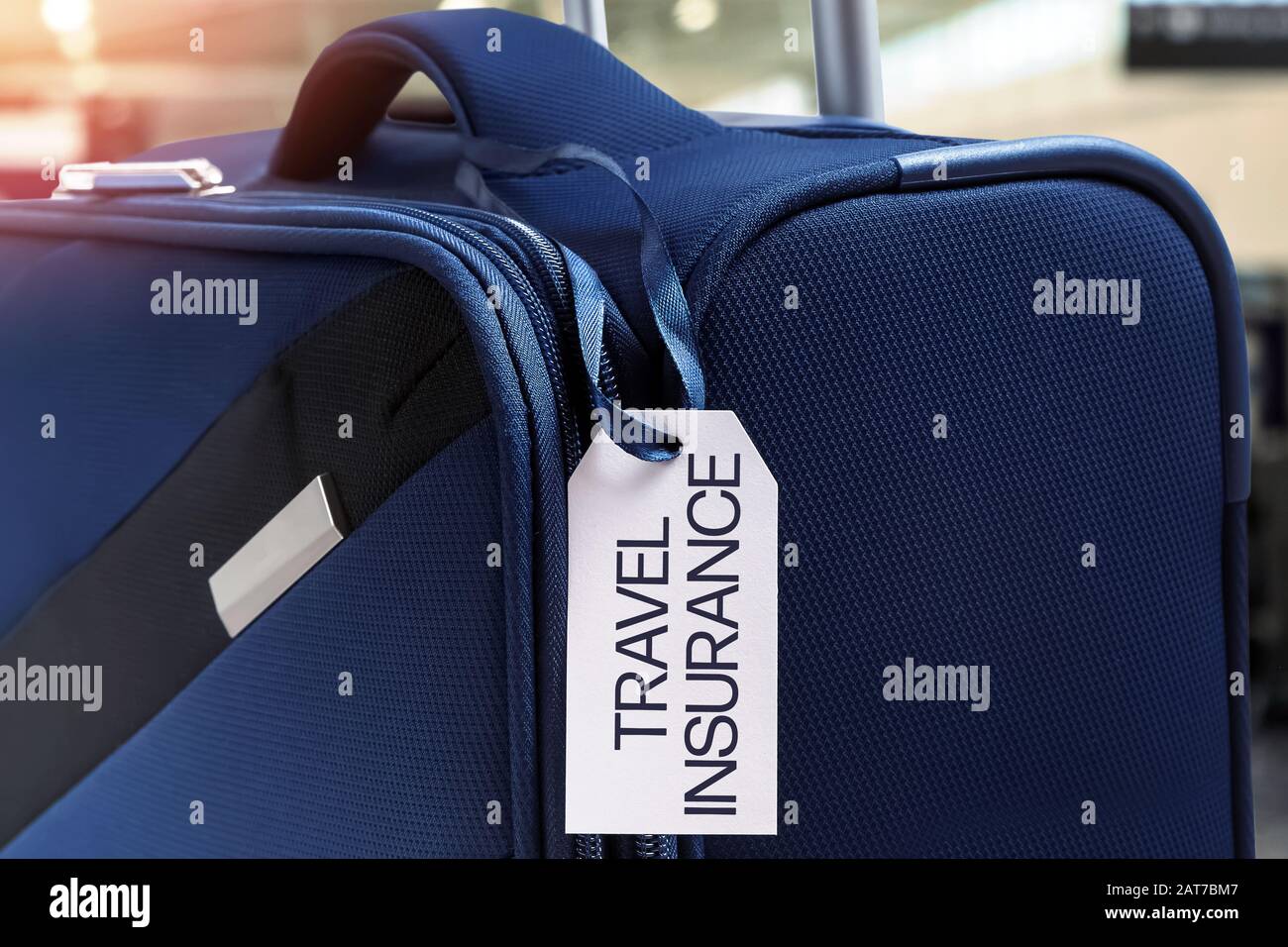 Blue suitcase with Travel Insurance label Stock Photo