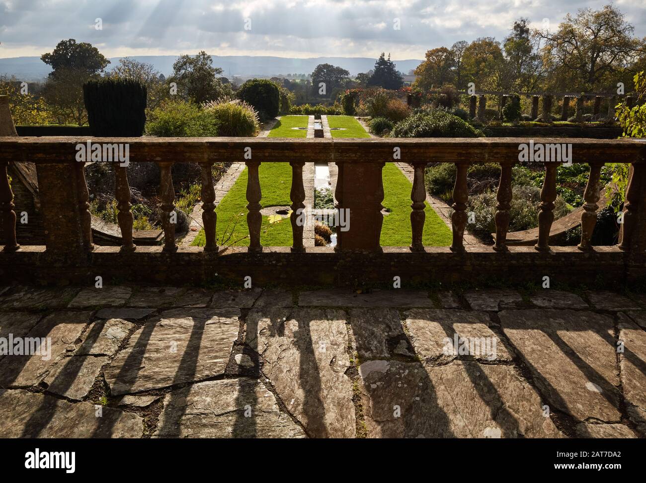 Looking over a stone balustrade in Hestercombe Gardens to a vista of the distant Blackdown Hills Somerset UK Stock Photo