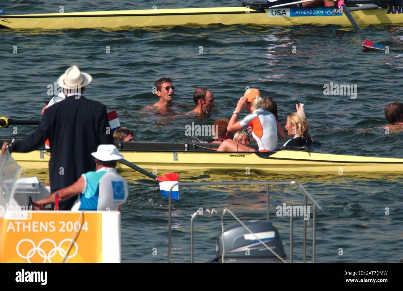 20040822 Olympic Games Athens Greece  [Rowing-Sun Finals day]  Lake Schinias.  Women's Olympic eights final from finish tower.   NED W8+ after winning the bronze medal are surrounded by  Dutch fans swimming out to congratulate the crew.  NED W8+ Marlies Smulders, 2. Nienke Hommes, 3. Froukji Wegman, 4. Hurnet Dekkers, 5. Sarah Siegelaar, 6. Annemiek de Haan, 7. Annemarieke van Rumpt, stroke Helen Tanger and cox Esther Worhel.    Photo  Peter Spurrier.   email images@intersport-images.com Stock Photo