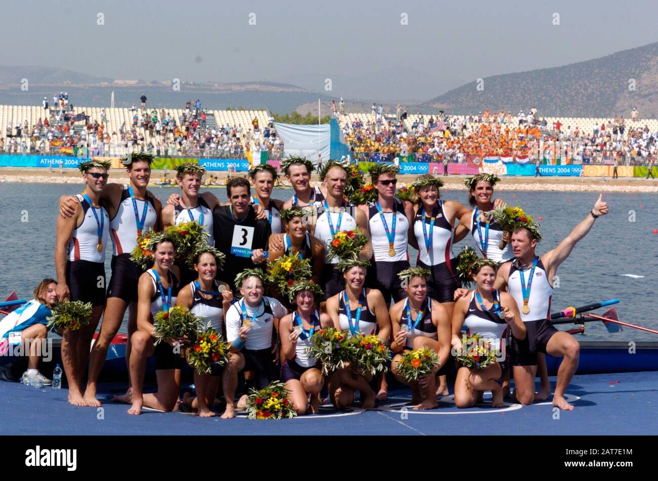 20040822 Olympic Games Athens Greece  [Rowing-Sun Finals day]  Lake Schinias. USA Men's coach Mike Teti joins the crews on the awards dock USA M8+ Gold medallist celebrate, after winning the final. bow. Jason Read, 2. Wyatt Allen, 3. Chris Ahrens, 4. Joseph Hansen, 5. Matt Deakin, 6. Daniel Beery, 7. Beau Hoopman, stroke Bryan Volpenhein and cox Pete Cipollone  Silver medallist - USA W8+ Kate Johnson, 2. Samantha Magee, 3. Megan Dirkmaat, 4. Alison Cox, 5. Caryn Davies, 6. Laurel Korholz, 7. Anna Mickelson stroke Lianne Nelson and cox Mary Whipple.  Photo  Peter Spurrier email images@interspor Stock Photo