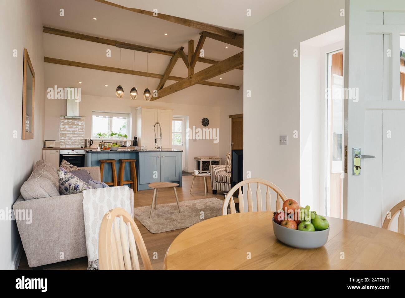 A wide-view shot of a modern living room and kitchen in Northeastern England. Stock Photo