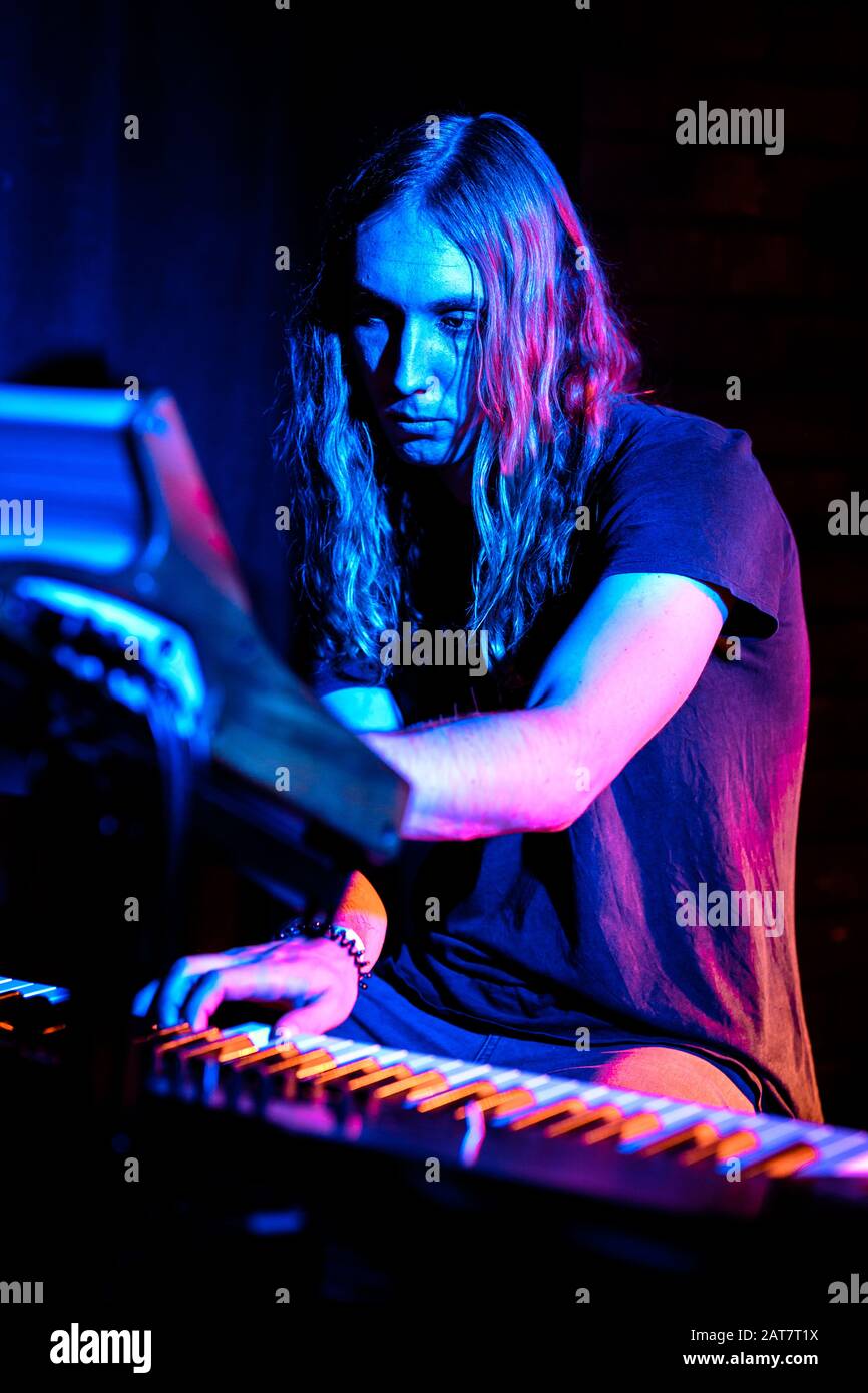 Blonde man with long hair playing keyboard Stock Photo - Alamy
