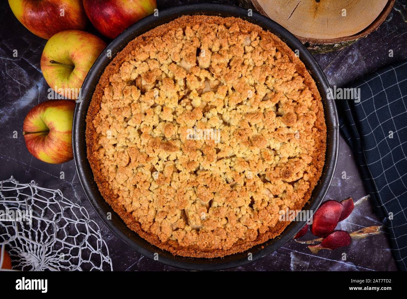 Whole traditional European apple pie with topping crumbles in
