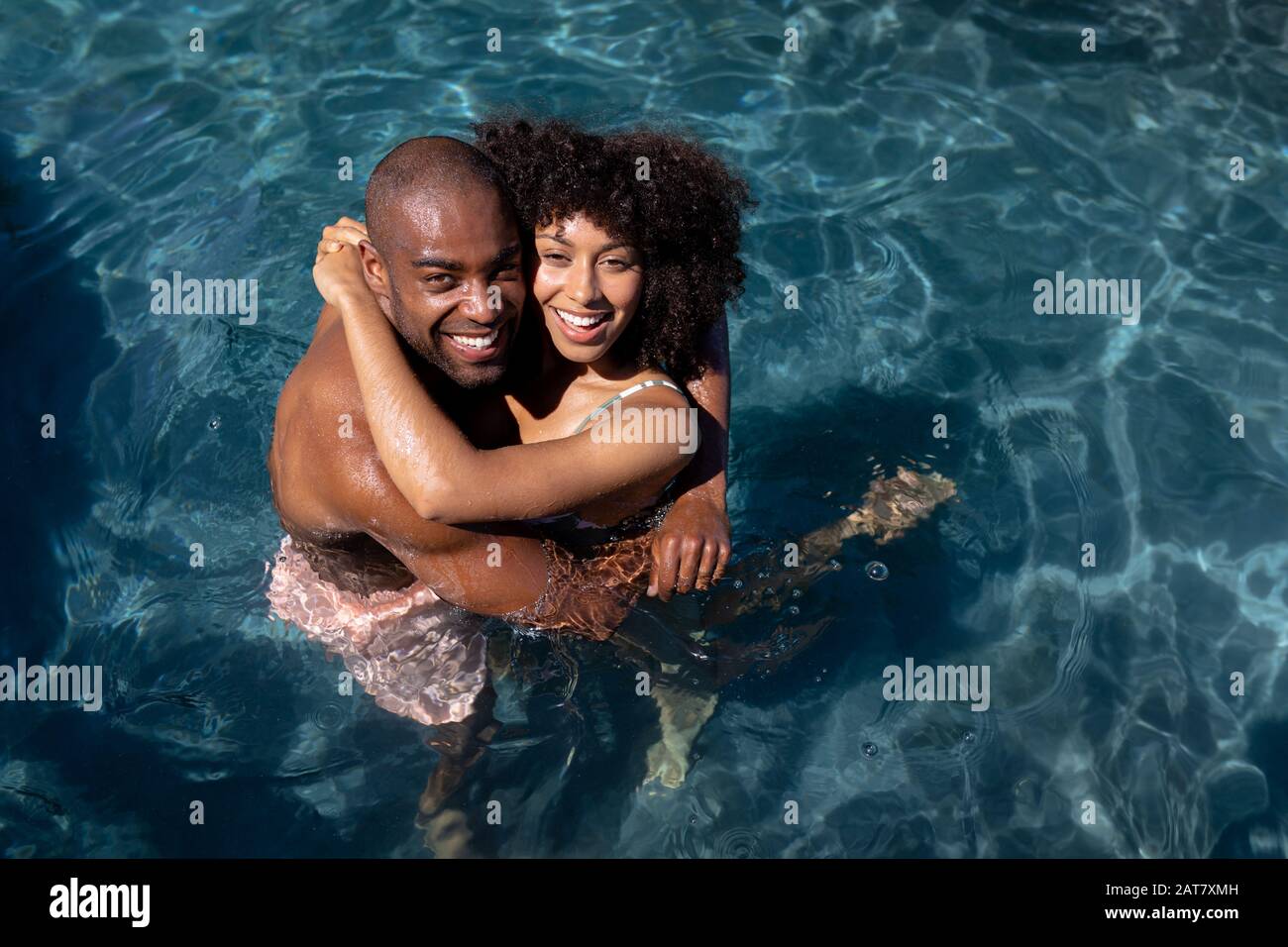Happy young couple relaxing near the swimming pool Stock Photo - Alamy