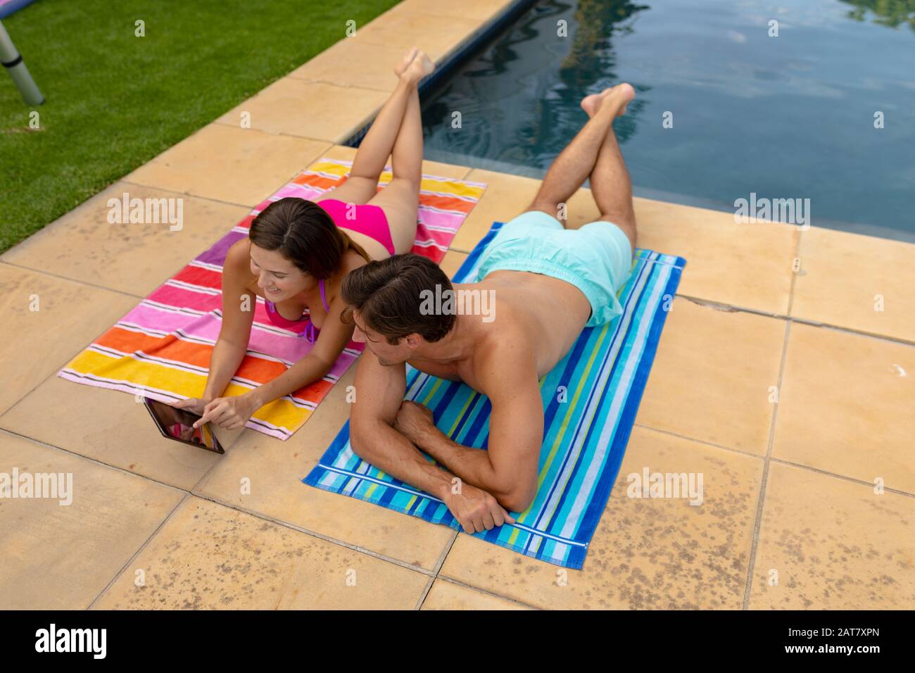 Happy young couple relaxing near the swimming pool Stock Photo