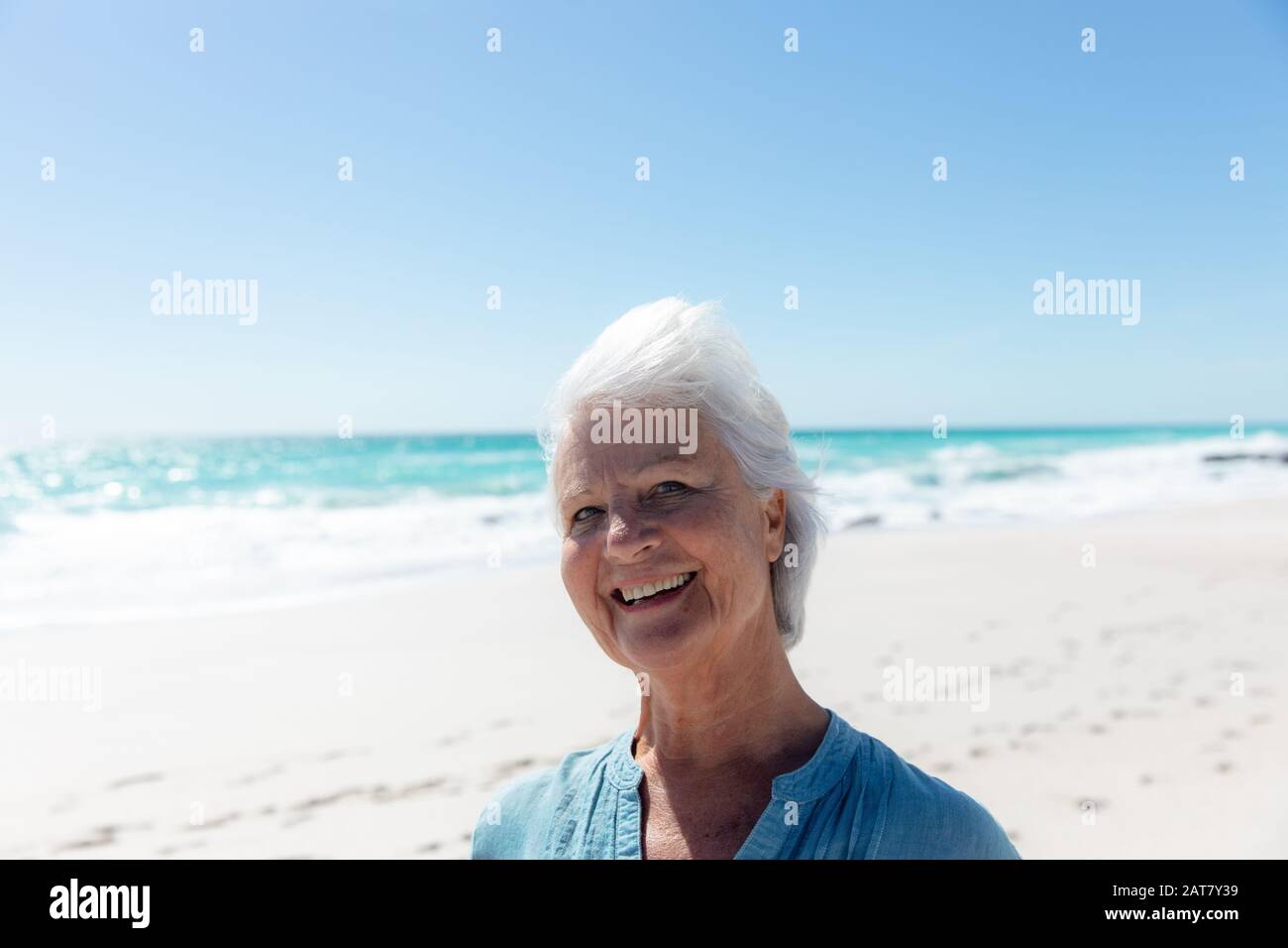 Old woman smiling at the beach Stock Photo - Alamy