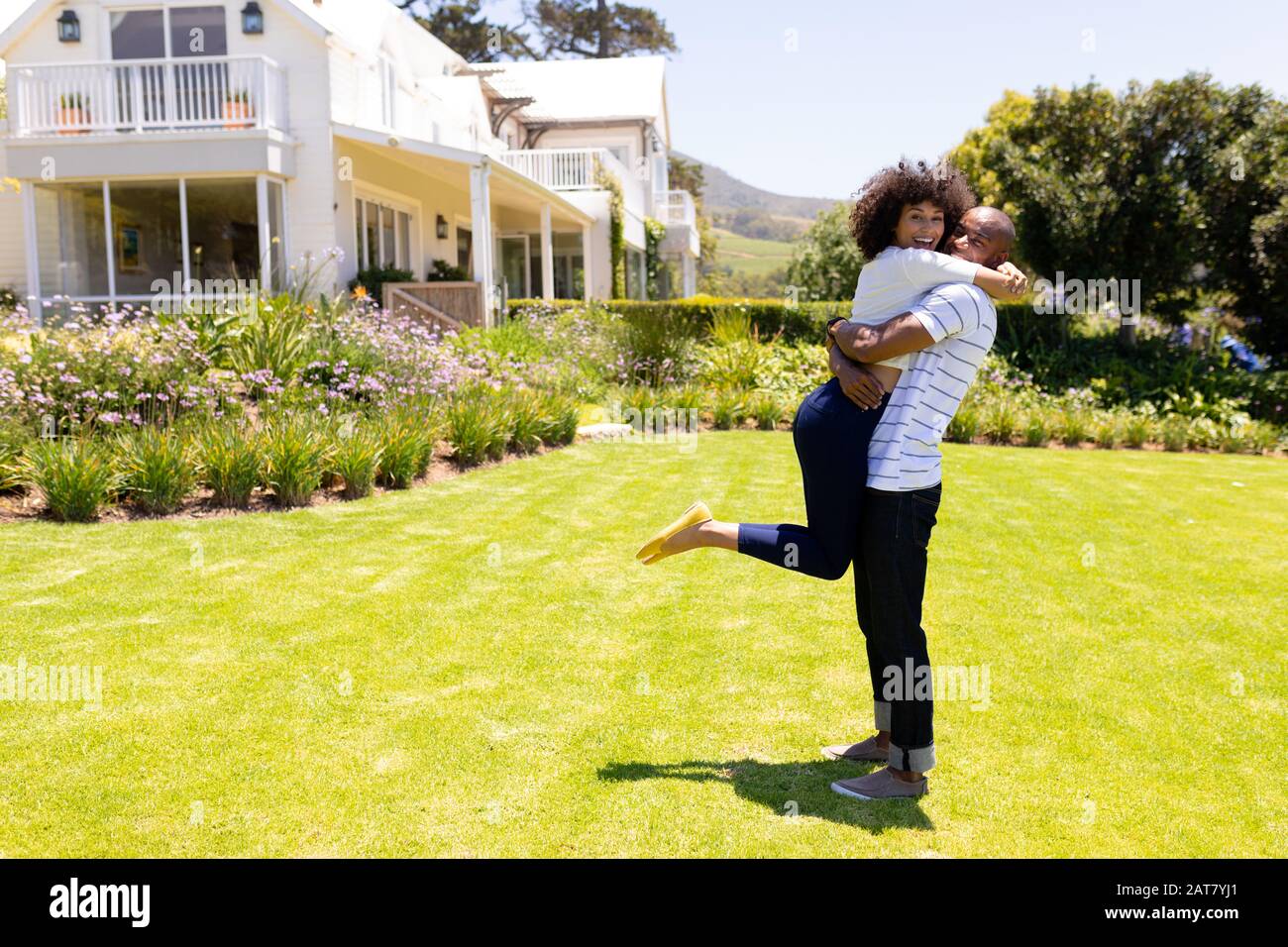 Young couple with arms around each other hi-res stock photography and ...