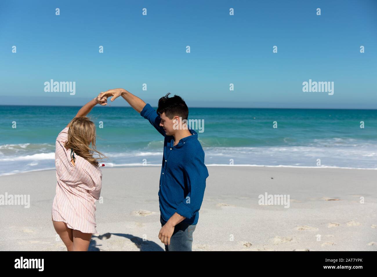 Young couple dancing at the beach Stock Photo